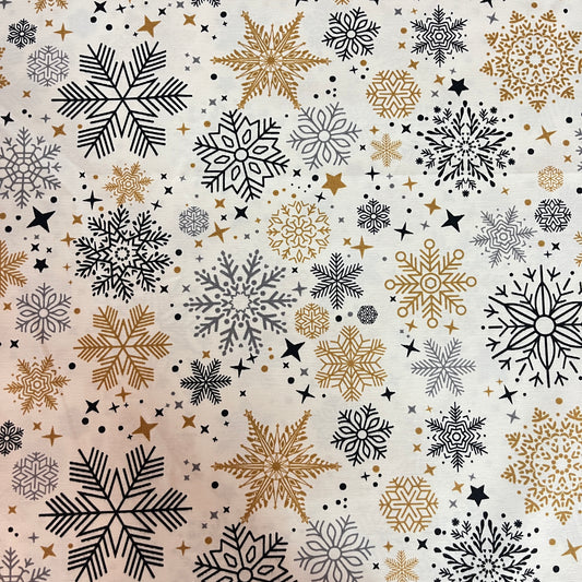 Toile déperlante de Noël flocons or et noir sur fond blanc, vue d'ensemble du motif - MyTissus